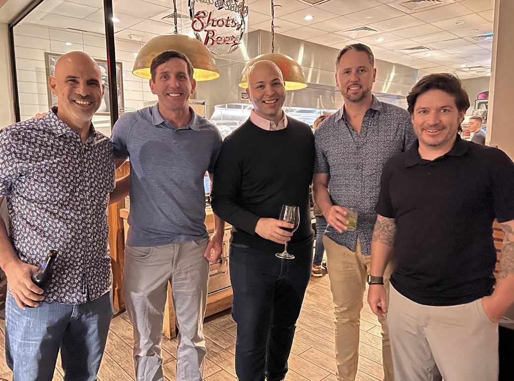 Members of sales and marketing, smiling for the camera.